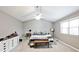 Spacious bedroom featuring neutral walls, ceiling fan, and bright window at 10234 Leeward Blvd, Indianapolis, IN 46256