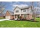 Charming two-story home with a brick and siding exterior, well-manicured lawn, and inviting curb appeal at 10234 Leeward Blvd, Indianapolis, IN 46256