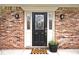 Close up of brick front door with decorative glass and sconces and a welcome mat at 10234 Leeward Blvd, Indianapolis, IN 46256