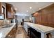 Modern kitchen with a large island, granite countertops, wood floors, and stainless steel appliances at 10234 Leeward Blvd, Indianapolis, IN 46256