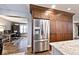Kitchen with wood cabinets, stainless steel refrigerator, and granite countertops at 10234 Leeward Blvd, Indianapolis, IN 46256
