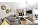 Living room with a large sectional couch, area rug, and stone fireplace with built-in shelving at 10234 Leeward Blvd, Indianapolis, IN 46256