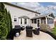 Back patio with wicker seating, string lights, and view of the backyard at 10234 Leeward Blvd, Indianapolis, IN 46256