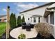 Backyard patio features stylish patio furniture, string lights, and manicured landscaping at 10234 Leeward Blvd, Indianapolis, IN 46256