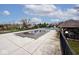 An outdoor pool area with protective cover, alongside a cabana, provides a secure and private space for recreation at 10234 Leeward Blvd, Indianapolis, IN 46256