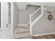 A carpeted stairway connects two floors of the home, with a door on the main floor at 10234 Leeward Blvd, Indianapolis, IN 46256