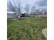Expansive backyard featuring a weeping willow and a row of evergreen trees, all fenced in at 1024 Foltz St, Indianapolis, IN 46241