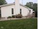 Backyard with manicured landscaping, including bushes and small trees at 1024 Foltz St, Indianapolis, IN 46241