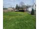 Fenced-in backyard featuring a multi-tiered wooden deck and green space at 1024 Foltz St, Indianapolis, IN 46241