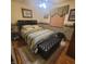 Cozy bedroom with green comforter, a ceiling fan, and wood flooring with an upholstered ottoman at 1024 Foltz St, Indianapolis, IN 46241
