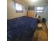 Comfortable bedroom featuring a large bed with plush bedding, two windows, and a dresser with a TV at 1024 Foltz St, Indianapolis, IN 46241