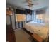 Unique bedroom with striped wallpaper, ceiling fan, and wooden window blinds with a mounted television at 1024 Foltz St, Indianapolis, IN 46241