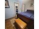 Bedroom with a wooden sleigh bed and matching wooden chest at 1024 Foltz St, Indianapolis, IN 46241