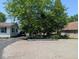 Driveway view of the home featuring white siding and mature trees at 1024 Foltz St, Indianapolis, IN 46241