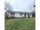 Charming single story home featuring a well-maintained lawn and black shutters at 1024 Foltz St, Indianapolis, IN 46241