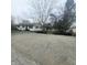 Wide shot of the single story home with gravel driveway and landscaping at 1024 Foltz St, Indianapolis, IN 46241