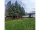 Exterior view of home with a well-maintained lawn and mature trees, providing ample shade at 1024 Foltz St, Indianapolis, IN 46241
