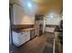 View of the kitchen featuring stainless steel appliances, wood floors, and white cabinets at 1024 Foltz St, Indianapolis, IN 46241