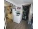 Convenient laundry room featuring a washing machine with a utility sink, shelving, and a storage area at 1024 Foltz St, Indianapolis, IN 46241