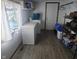 Practical laundry room with a freezer, washer, dryer, storage shelves, and white wood door at 1024 Foltz St, Indianapolis, IN 46241