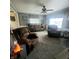 Inviting living room with three large seating arrangements, window treatments, and neutral carpet at 1024 Foltz St, Indianapolis, IN 46241