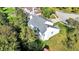 A high angle view reveals a home's roof, deck, backyard, and proximity to lush greenery at 10401 Monarch Ct, Noblesville, IN 46060