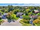 Stunning aerial view of a brick home featuring a lush green lawn and surrounded by mature trees in a serene neighborhood at 10401 Monarch Ct, Noblesville, IN 46060