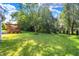 Spacious backyard with a deck, lawn, and surrounding trees, offering a peaceful outdoor space at 10401 Monarch Ct, Noblesville, IN 46060
