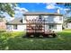 Exterior view of a home with a spacious backyard featuring a deck with a pergola and a well-maintained lawn at 10401 Monarch Ct, Noblesville, IN 46060