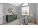 Cozy Bedroom featuring a crib, dresser, and ample natural light from large window at 10401 Monarch Ct, Noblesville, IN 46060
