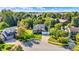 Aerial view of a brick home with a well-manicured lawn and a long driveway in a suburban neighborhood at 10401 Monarch Ct, Noblesville, IN 46060