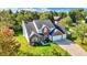 An aerial perspective showcases a two-story brick home with a manicured lawn and a two car attached garage at 10401 Monarch Ct, Noblesville, IN 46060
