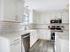 Modern kitchen showcasing white cabinets, quartz countertops, and stainless steel appliances at 10401 Monarch Ct, Noblesville, IN 46060