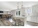 Open-concept kitchen featuring an island, stainless appliances and views into the living area at 10401 Monarch Ct, Noblesville, IN 46060