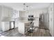 Modern kitchen with white cabinetry, stainless steel appliances, and an island at 10401 Monarch Ct, Noblesville, IN 46060