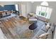 Bright, open living room with hardwood floors, a vaulted ceiling, and a view of the dining area at 10401 Monarch Ct, Noblesville, IN 46060