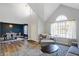 Bright living room features vaulted ceiling, big window and open-concept design into the dining area at 10401 Monarch Ct, Noblesville, IN 46060