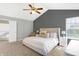 Bright main bedroom with neutral colors, vaulted ceiling, ceiling fan, and an ensuite bathroom at 10401 Monarch Ct, Noblesville, IN 46060