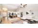 Open-concept living room with vaulted ceilings, seamlessly connecting the kitchen and dining area at 10554 Crystal Coop Ln, Indianapolis, IN 46235