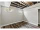 Unfinished basement with wood look flooring, small windows and exposed ceiling at 10611 Proposal Pointe Way, Fishers, IN 46040