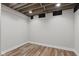 Unfinished basement with wood look flooring and exposed ceiling at 10611 Proposal Pointe Way, Fishers, IN 46040