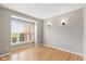 Bright bedroom with hardwood floors, neutral paint, and large window at 10611 Proposal Pointe Way, Fishers, IN 46040
