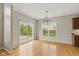 Bright dining room featuring a modern chandelier and sliding glass doors to the outdoor patio at 10611 Proposal Pointe Way, Fishers, IN 46040