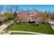 Beautiful two-story brick home featuring a well-manicured lawn and lovely landscaping at 10611 Proposal Pointe Way, Fishers, IN 46040