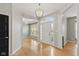 Elegant foyer with hardwood floors, chandelier, and large front door at 10611 Proposal Pointe Way, Fishers, IN 46040