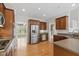 Spacious kitchen with stainless steel appliances, warm wood cabinets, and ample counter space at 10611 Proposal Pointe Way, Fishers, IN 46040