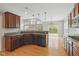 Spacious kitchen with stainless appliances open to living room with fireplace and large windows at 10611 Proposal Pointe Way, Fishers, IN 46040