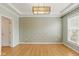Open living room with hardwood floors and elegant wallpaper at 10611 Proposal Pointe Way, Fishers, IN 46040