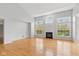 Spacious living room with hardwood floors, fireplace, and many windows at 10611 Proposal Pointe Way, Fishers, IN 46040