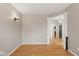 Open living room with hardwood floors and view of hallway at 10611 Proposal Pointe Way, Fishers, IN 46040